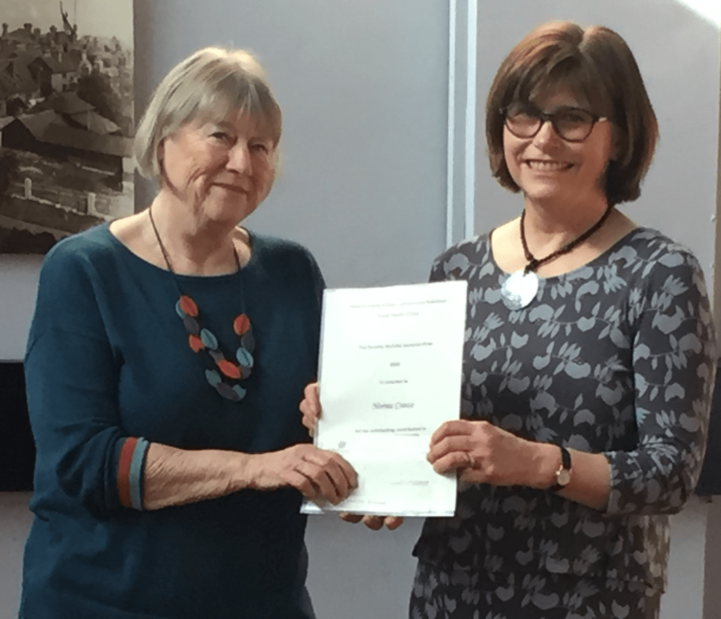 Norma Crowe receiving her certificate for the McCulla Award.